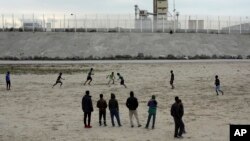 Migrants play soccer in a makeshift camp that has been dubbed "Jungle" by its residents, in Calais, France, Oct. 12, 2016. 