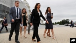 House Speaker Nancy Pelosi of Calif., second from right, arrives for a news conference on veteran suicide prevention with House Veterans' Committee members, April 29, 2019, at the House Triangle in Washington.