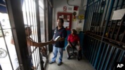 A customer punches in his pin code at a branch of the Autopartes Guarico 2000, one of 3 owned by the David brothers in Santa Teresa Del Tuy, Venezuela, Sept. 5, 2018.