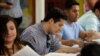FILE - Ernesto Delgado, center, a Deferred Action for Childhood Arrivals (DACA) recipient, fills out his renewal application during the immigration ministry at Lincoln Methodist Church in Chicago, Sept. 10, 2017. 