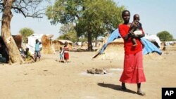 Darfur's displaced set up huts near and old airstrip in the village of Jaac in southern Sudan.