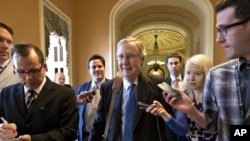 Senate Minority Leader Mitch McConnell of Kentucky, center, arrives at his office in the Capitol as he and Senate Majority Leader Harry Reid of Neveda try to negotiate a legislative solution to avoid the so-called "fiscal cliff", Sunday, December 30, 2012.