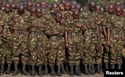 FILE - Members of the Kenya Defence Forces say prayers to pay respects to the Kenyan soldiers serving in the African Union Mission in Somalia (AMISOM), who were killed in El Adde during an attack, at a memorial mass at the Moi Barracks in Eldoret, Jan. 27, 2016.