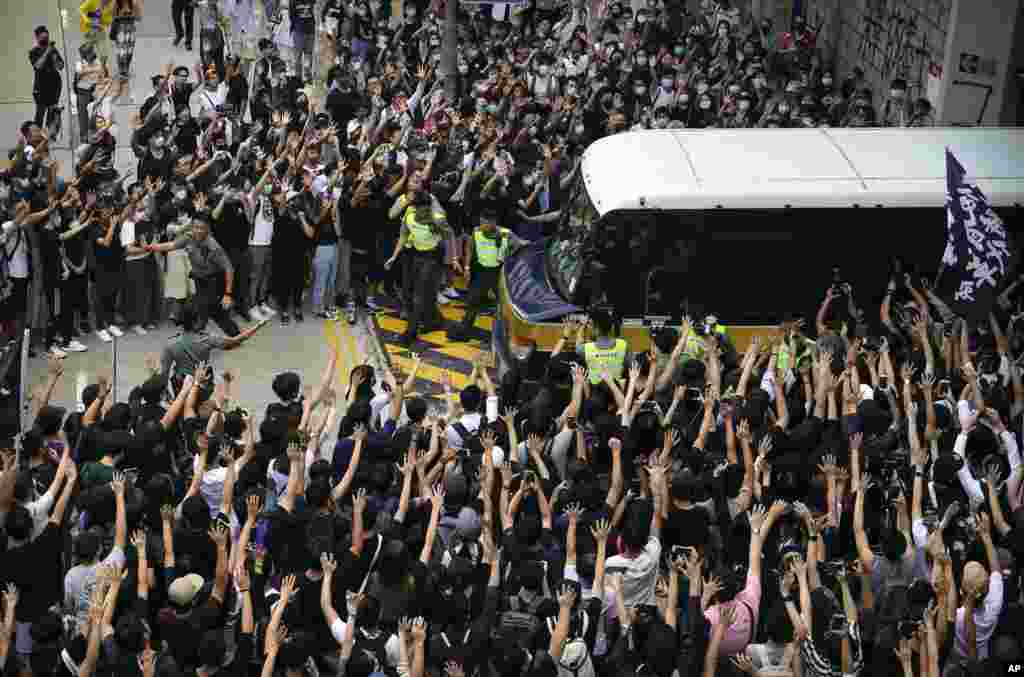 Supporters surround a police bus carrying political activist Edward Leung as it leaves the High Court in Hong Kong.