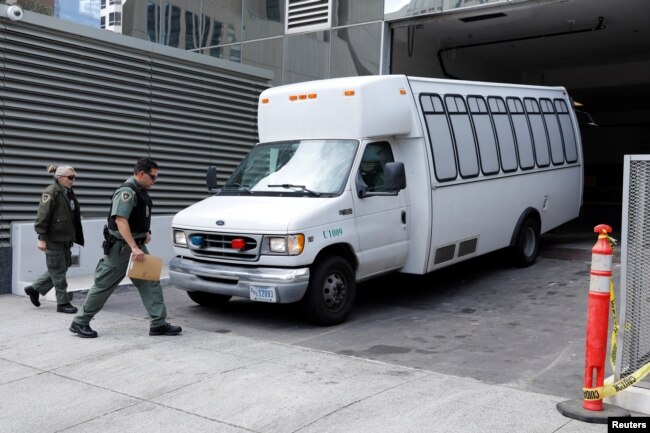 FILE - A vehicle carrying asylum-seekers brought from Tijuana, Mexico, to the United States for their immigration hearing arrives at a court in San Diego, California, March 19, 2019.