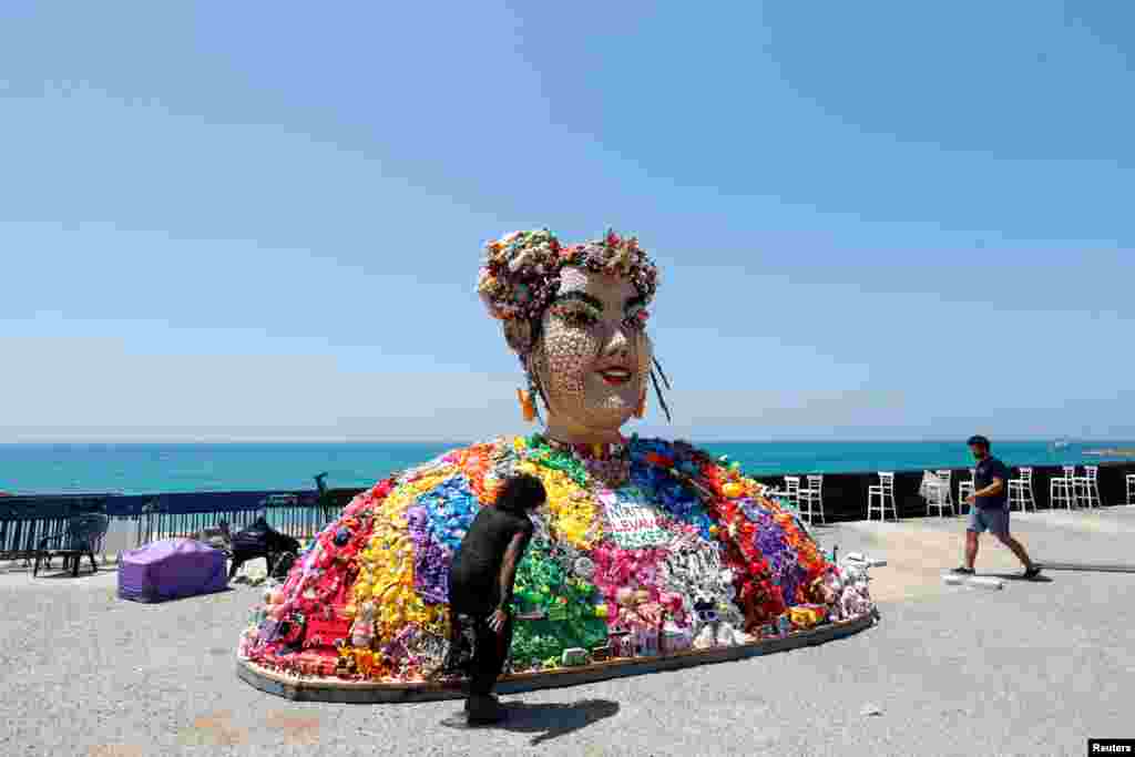 Israeli artist Nirit Levav Packer looks at her artwork entitled &quot;Toy&quot;, the name of the last year&#39;s Eurovision Song Contest winning song by Israel&#39;s Netta Barzilai, as the opening ceremony of this year&#39;s contest begins tonight, in Tel Aviv.