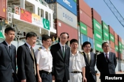 FILE - Chinese Ambassador to Pakistan, Sun Weidong (C), poses for pictures with members of his staff and crew of the first container ship to depart after the inauguration of the China Pakistan Economic Corridor port in Gwadar, Pakistan, Nov. 13, 2016.