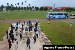 FILE - Cambodia naval personnel walk with journalists during a government organized media tour to the Ream naval base in Preah Sihanouk province on July 26, 2019.