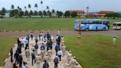 Cambodia naval personnel walk with journalists during a government organized media tour to the Ream naval base in Preah Sihanouk province on July 26, 2019.