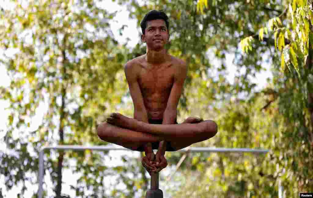 A performer practices &quot;Malkhamb&quot; (traditional Indian gymnastics) during a rehearsal for the upcoming annual Rath Yatra, or chariot procession, in Ahmedabad, India, June 10, 2017.