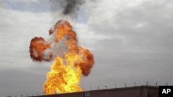 Flames are seen after an explosion went off at a gas terminal in Egypt's northern Sinai Peninsula, February 5, 2011, in El-Arish, setting off a massive fire