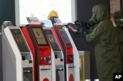 A hazmat crew scana the check-in kiosk machines at Kuala Lumpur International Airport 2 in Sepang, Malaysia, Feb. 26, 2017.