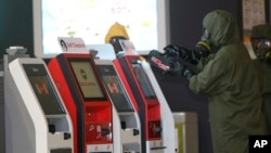 FILE - A hazmat crew scan the check-in kiosk machines at Kuala Lumpur International Airport 2 in Sepang, Malaysia, Feb. 26, 2017. Malaysian police ordered a sweep of Kuala Lumpur airport for toxic chemicals and other hazardous substances following the killing of Kim Jong Nam.