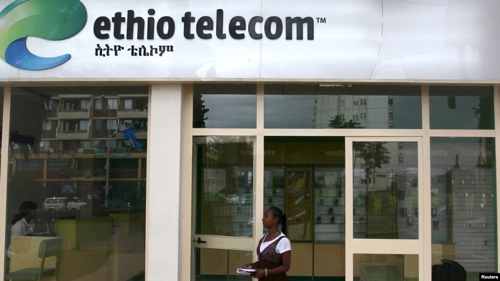 FILE - A woman walks past an Ethio Telecom office in Ethiopia's capital, Addis Ababa, Nov. 9, 2015.