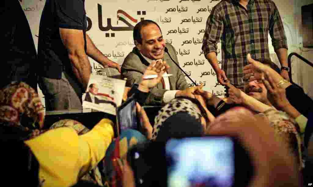 This photo released by the presidential campaign of Abdel-Fattah el-Sissi shows the candidate greeting supporters at a gathering of about 600 women, in Cairo, May 5, 2014.