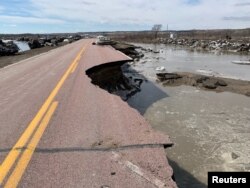 A damaged road is seen after a storm triggered historic flooding in Niobrara, Nebraska, March 16, 2019.