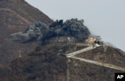 An explosion is part of the dismantling of a South Korean guard post in the Demilitarized Zone dividing the two Koreas in Cheorwon, Nov. 15, 2018. Relations between the Koreas have improved this year, with the North entering disarmament talks with a vague promise to achieve complete denuclearization of the Korean Peninsula.