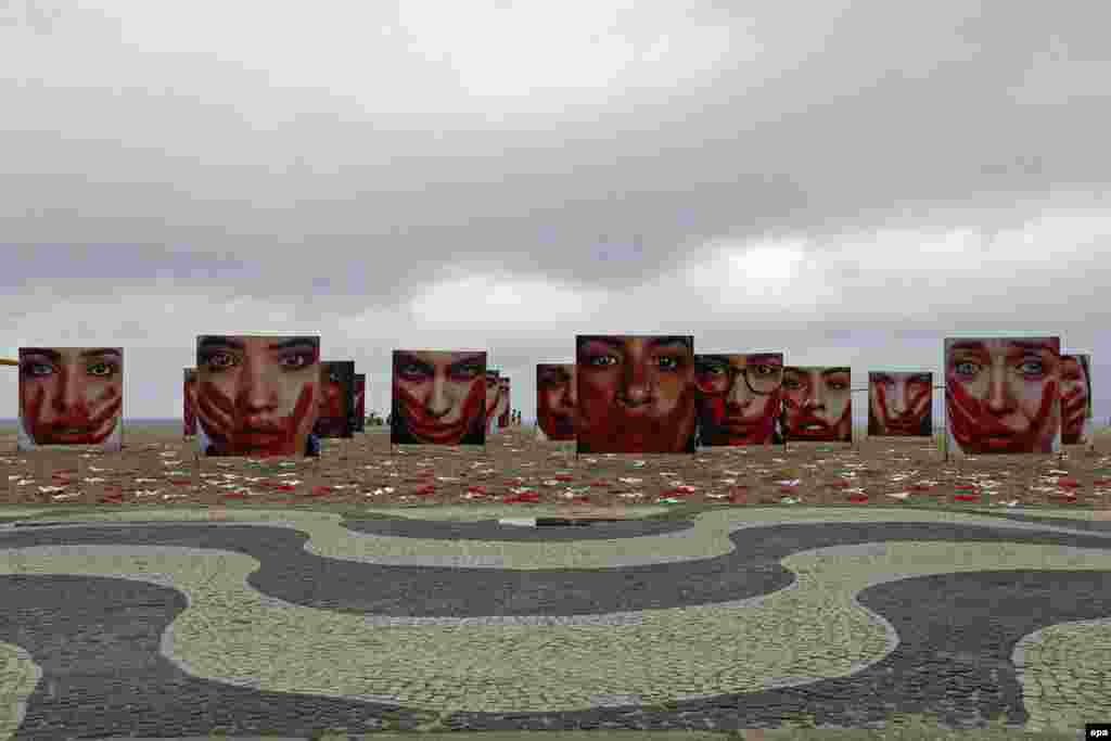 General view of an installation by NGO Rio de Paz shows pictures of models taken by Marcio Freitas, representing female victims of sexual abuse and 420 underpants that represent the number of women raped in the country every 72 hours, at Copacabana beach in Rio de Janeiro, Brazil.