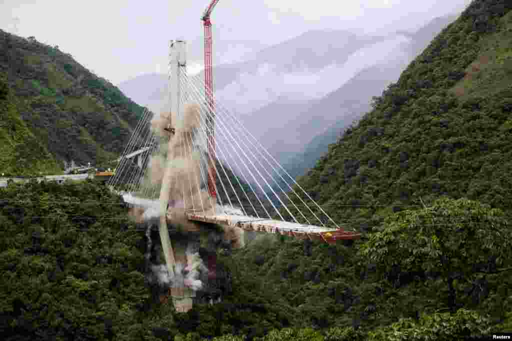 The Chirajara bridge is demolished in a controlled implosion, after it partially collapsed killing several people earlier this year, in Guayabetal, Colombia, July 11, 2018.