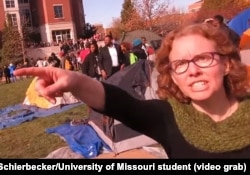 University of Missouri communications professor Melissa Click is seen in a screenshot from a video shot by University of Missouri student photographer Mark Schierbecker, telling the photographer he "needs to go" and can't videotape the student protesters.