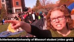 University of Missouri communications professor Melissa Click is seen in a screenshot from a video shot by University of Missouri student photographer Mark Schierbecker, telling the photographer he "needs to go" and can't videotape the student protesters,