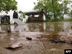 FILE - Two Myanmar policemen monitor a checkpoint at the entrance of Yathae Taung township in Rakhine State, Aug. 26, 2017.