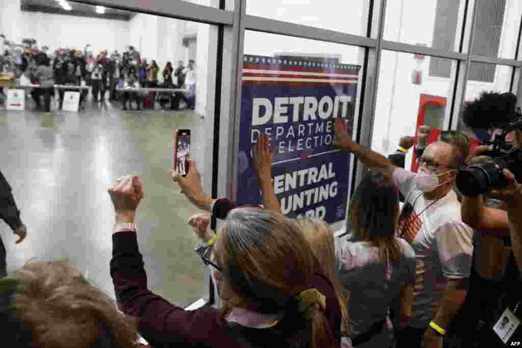 Supporters of U.S. President Donald Trump bang on the glass and chant slogans outside the room where absentee ballots for the 2020 general election are being counted at TCF Center in Detroit, Michigan, Nov. 4, 2020.