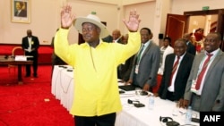 FILE - Ugandan President Yoweri Museveni gestures to delegates attending the Burundi peace talks at Entebbe State House, east of Kampala, Dec. 28, 2015.