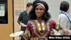 Tricia Gabriel, co-founder of Genesis Youth Foundation, hands out snacks to children in the program, in Des Moines, Iowa, Jan. 28, 2019.