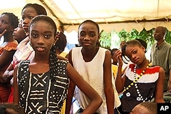 Girls prepare to go on stage for their performance on the rights of the child