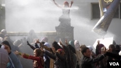 Water cannon are fired on female students during a protest at Al-Azhar University in Cairo, Dec. 11, 2013. (Hamada Elrasam for VOA)