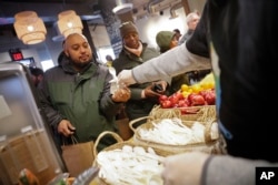 A volunteer hands out utensils at Chef Jose Andres' World Central Kitchen while also serving free meals to workers effected by the government shutdown in Washington January 16, 2019.