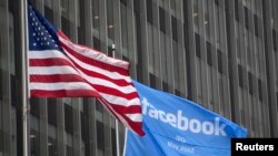 Le drapeau de facebook flotte a coté du drapeau américain a New York, USA le 4 mai 2012