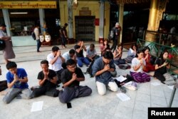 FILE - Friends and relatives of arrested Reuters journalists Wa Lone and Kyaw Soe Oo pray at Shwedagon Pagoda in Yangon, Myanmar, Jan. 7, 2018.