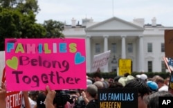FILE - Activists march past the White House to protest the Trump administration's approach to illegal border crossings and separation of children from immigrant parents in Washington, June 20, 2018.