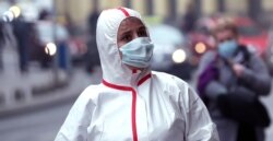 A woman wearing a face mask walks in Sarajevo, in the midst of the COVID-19 coronavirus pandemic, in Sarajevo, Bosnia and Herzegovina, 10 November 2020. EPA-EFE/FEHIM DEMIR