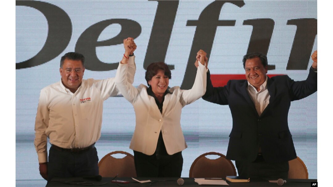 Schoolteacher-turned-politician and Mexico state gubernatorial candidate for the National Regeneration Movement, or MORENA, Delfina Gomez, center, greets supporters at her party's headquarters in Toluca, Mexico, June 4, 2017.
