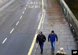 FILE - An image grab from CCTV, issued by the Metropolitan Police in London Sept. 5, 2018, shows men then identified as Ruslan Boshirov and Alexander Petrov (R) walking on Fisherton Road, Salisbury, England, March 4, 2018. Boshirov has been unmasked as decorated Russian agent Anatoliy Chepiga while Petrov has been identified as trained army doctor Alexander Mishkin.