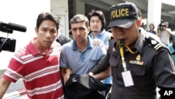 Thai police officers escort Iranian suspect Mohammad Khazaei (C) at the Immigration Bureau in Bangkok February 16, 2012.