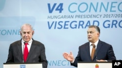 Israeli Prime Minister Benjamin Netanyahu, left, listens to Hungarian Prime Minister Viktor Orban during a press conference held after the talks of Netanyahu with heads of government of the Visegrad Group or V4 countries in the Pesti Vigado building in Bu