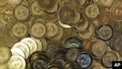 FILE - Bitcoin tokens at software engineer Mike Caldwell's shop in Sandy, Utah, April 3, 2013. 