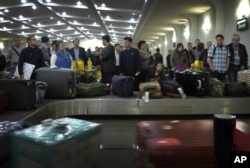 FILE - Passengers wait for their luggage upon arrival at the Sunan International Airport in Pyongyang, North Korea, Oct. 21, 2014.