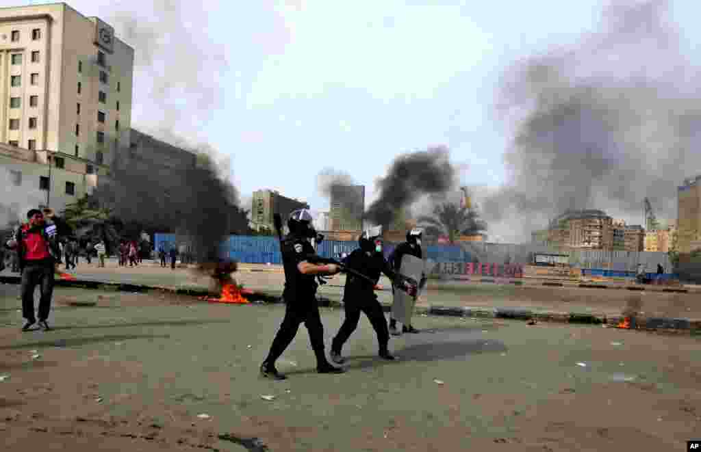 Egyptian riot police clash with protesters, not seen, near Tahrir Square, Cairo, Egypt, January 27, 2013.