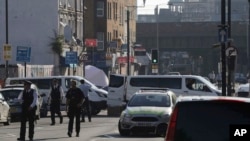 A forensic tent and police are seen on Seven Sisters Road looking to Finsbury Park Mosque after a vehicle struck pedestrians in north London, June 19, 2017.