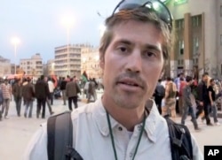 FILE - This undated file still image from video released April 7, 2011, by GlobalPost, shows James Foley of Rochester, N.H., a freelance contributor for GlobalPost, in Benghazi, Libya.