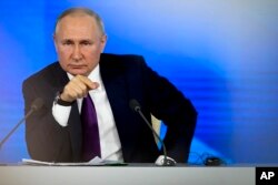 Vladimir Putin attends his annual press conference in Moscow on December 23, 2021. The Russian president urged the West to 