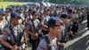 Members of Indonesian National Police elite unit "Mobile Brigade" stand in attention during a security show of force ahead of Christmas and New Year celebrations at the National Monument in Jakarta, Indonesia, Thursday, Dec. 22, 2016.