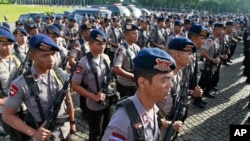 Members of Indonesian National Police elite unit "Mobile Brigade" stand in attention during a security show of force ahead of Christmas and New Year celebrations at the National Monument in Jakarta, Indonesia, Thursday, Dec. 22, 2016.