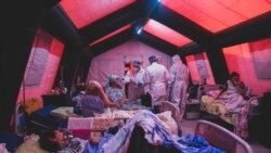 FILE: Medical staff treat a coronavirus patient at a tent hospital erected for COVID-19 patients in Kakhovka, Ukraine, Nov. 7, 2021.