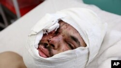 Hasib Sadat, an Afghan journalist injured from yesterday's suicide attack near the Russian Embassy, lays on a bed at a hospital in Kabul, Afghanistan, Jan. 21, 2016.